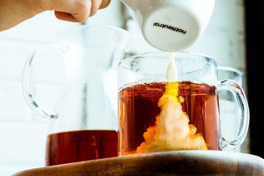 milk being poured into tea